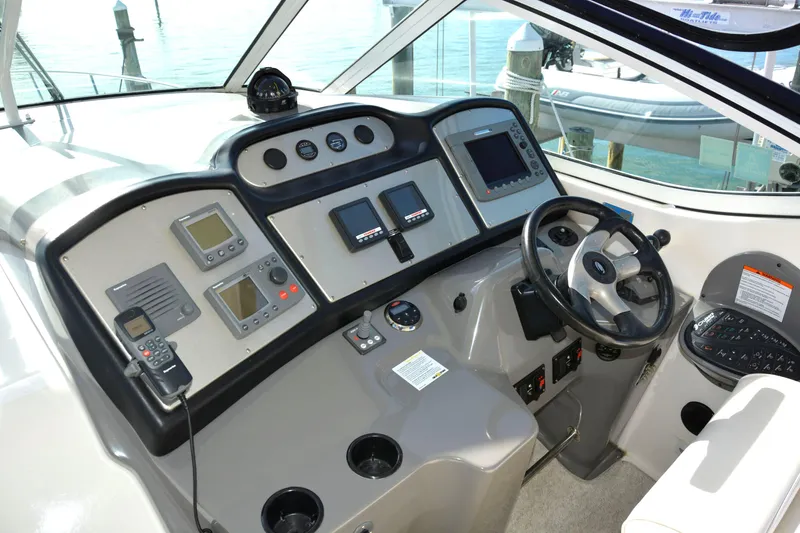 Slide: The Image of 2006 Cruisers Yachts 415 Express Motoryacht helm with navigation instruments and steering wheel. - 19