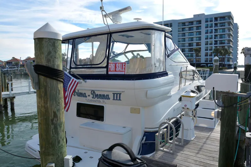 Slide: The Image of 2006 Cruisers Yachts 415 Express Motoryacht docked with "For Sale" sign. - 2