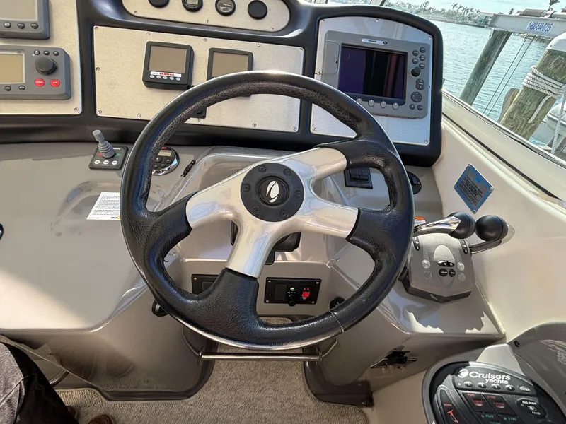Slide: The Image of Helm of 2006 Cruisers Yachts 415 Express Motoryacht with steering wheel and navigation controls. - 20