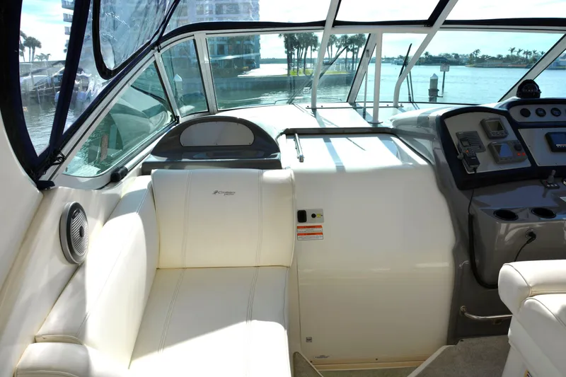Slide: The Image of 2006 Cruisers Yachts 415 Express Motoryacht interior with helm and seating, overlooking water. - 27
