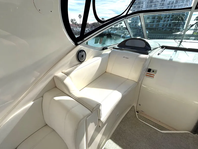 Slide: The Image of 2006 Cruisers Yachts 415 Express Motoryacht interior with white seating and helm view. - 28