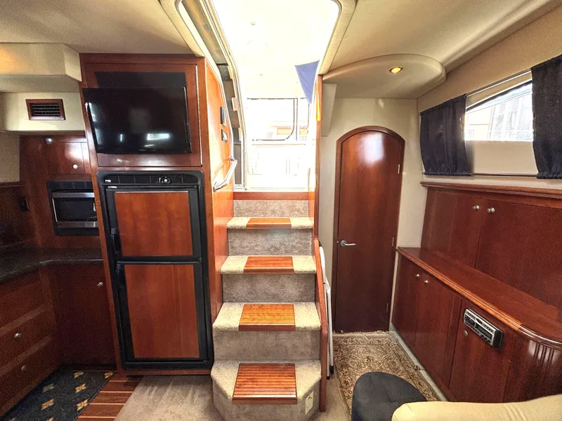 Slide: The Image of Interior of 2006 Cruisers Yachts 415 Express Motoryacht with wood finishes and modern amenities. - 29