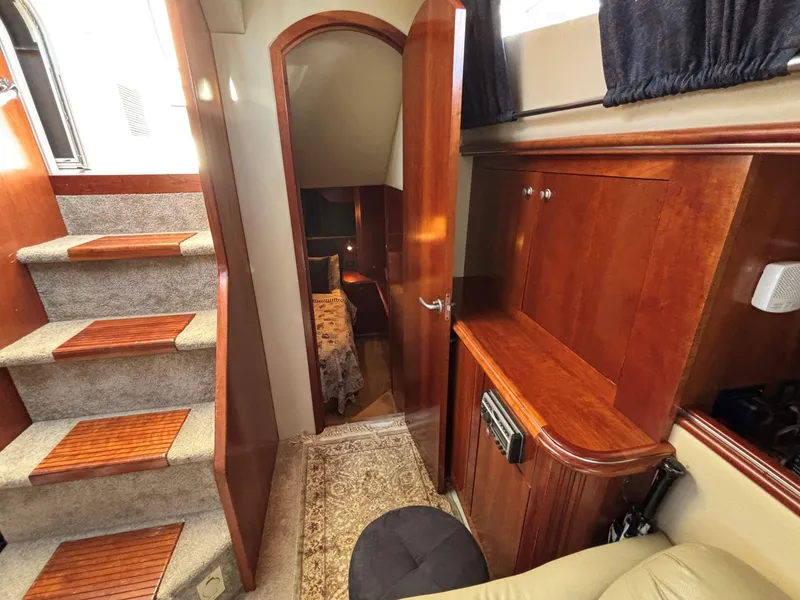 Slide: The Image of Interior of 2006 Cruisers Yachts 415 Express Motoryacht with wooden cabinetry and carpeted stairs. - 30
