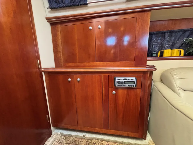 Slide: The Image of 2006 Cruisers Yachts 415 Express Motoryacht interior with wooden cabinetry and built-in stereo system. - 32
