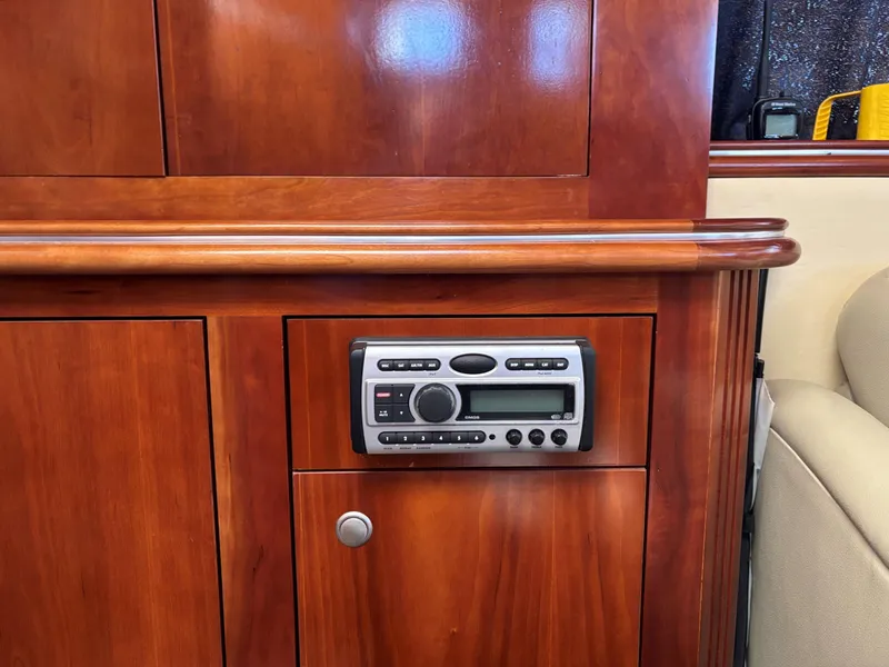 Slide: The Image of 2006 Cruisers Yachts 415 Express Motoryacht interior with wood paneling and built-in stereo system. - 33