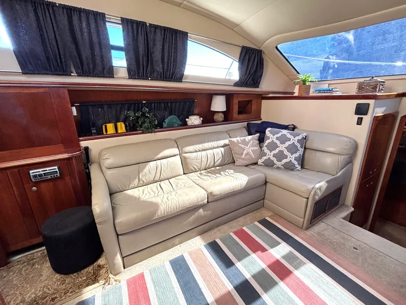 Slide: The Image of Interior of 2006 Cruisers Yachts 415 Express Motoryacht with beige leather sofa and colorful rug. - 35