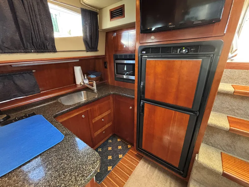 Slide: The Image of Interior of 2006 Cruisers Yachts 415 Express Motoryacht with kitchen amenities. - 39