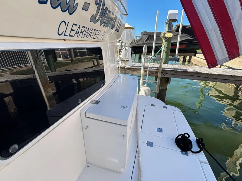 Slide: The Image of 2006 Cruisers Yachts 415 Express Motoryacht docked, featuring deck and water view. - 4