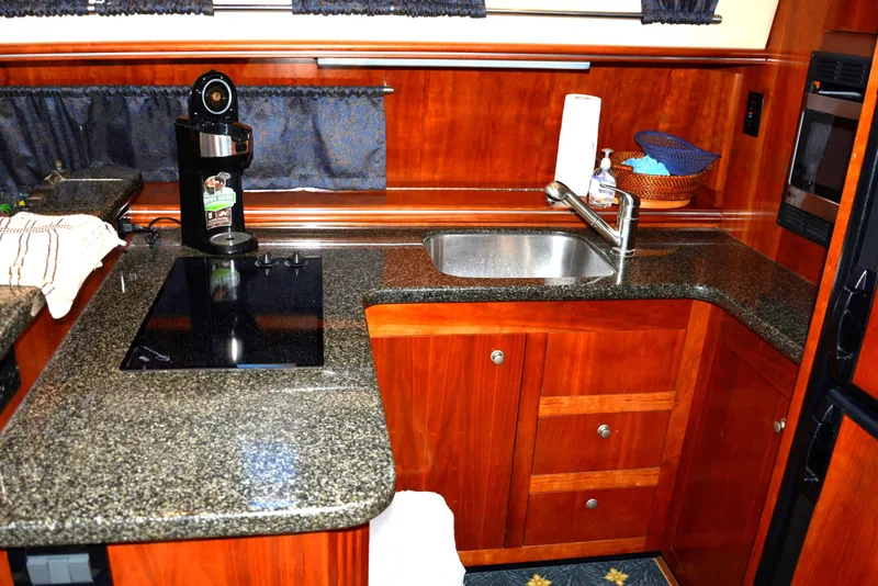 Slide: The Image of Luxurious kitchen in 2006 Cruisers Yachts 415 Express Motoryacht with granite countertops and modern appliances. - 40
