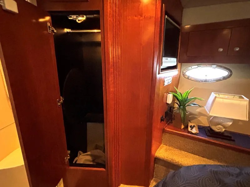 Slide: The Image of 2006 Cruisers Yachts 415 Express Motoryacht interior with wood cabinetry and porthole window. - 48