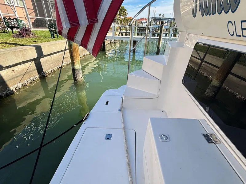 Slide: The Image of 2006 Cruisers Yachts 415 Express Motoryacht docked with American flag. - 5