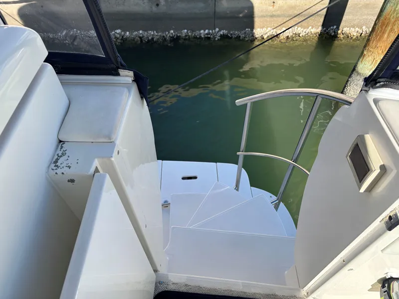 Slide: The Image of 2006 Cruisers Yachts 415 Express Motoryacht, stairway to water, docked in marina. - 6