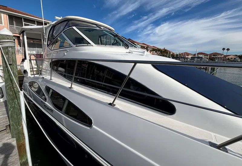 Slide: The Image of 2006 Cruisers Yachts 415 Express Motoryacht docked under a clear blue sky. - 8