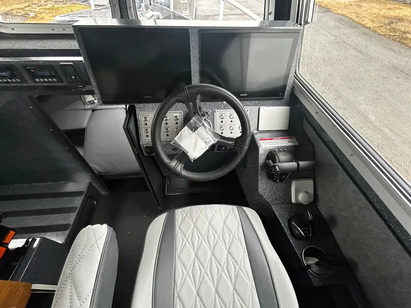 Slide: The Image of Interior cockpit of 2025 Duckworth 30 XL boat with dual screens and steering wheel. - 12