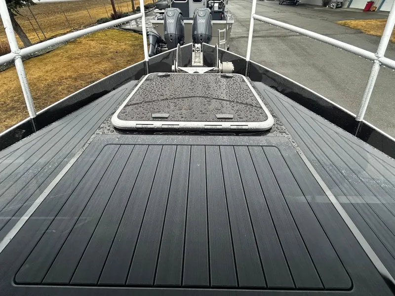 Slide: The Image of Duckworth 30 XL 2025 boat deck with rain droplets, featuring dual outboard motors. - 17