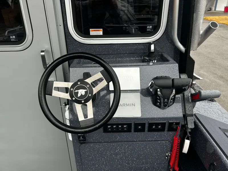Slide: The Image of Control panel of a 2025 Duckworth 30 XL boat with steering wheel and throttle. - 5