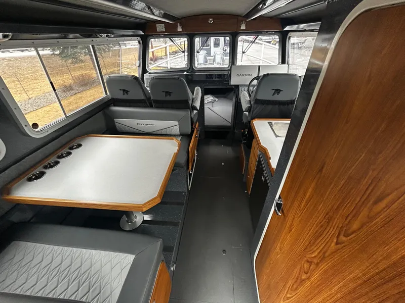 Slide: The Image of Interior of 2025 Duckworth 30 XL boat, featuring seating and navigation area. - 7