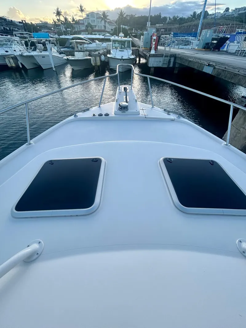 Slide: The Image of 2021 Grady-White Express 330 boat docked at marina, view from bow. - 11