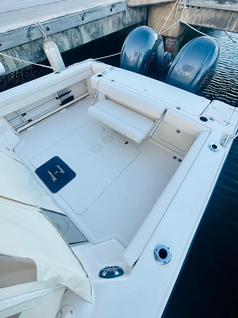 Slide: The Image of 2021 Grady-White Express 330 boat with dual engines docked at marina. - 13