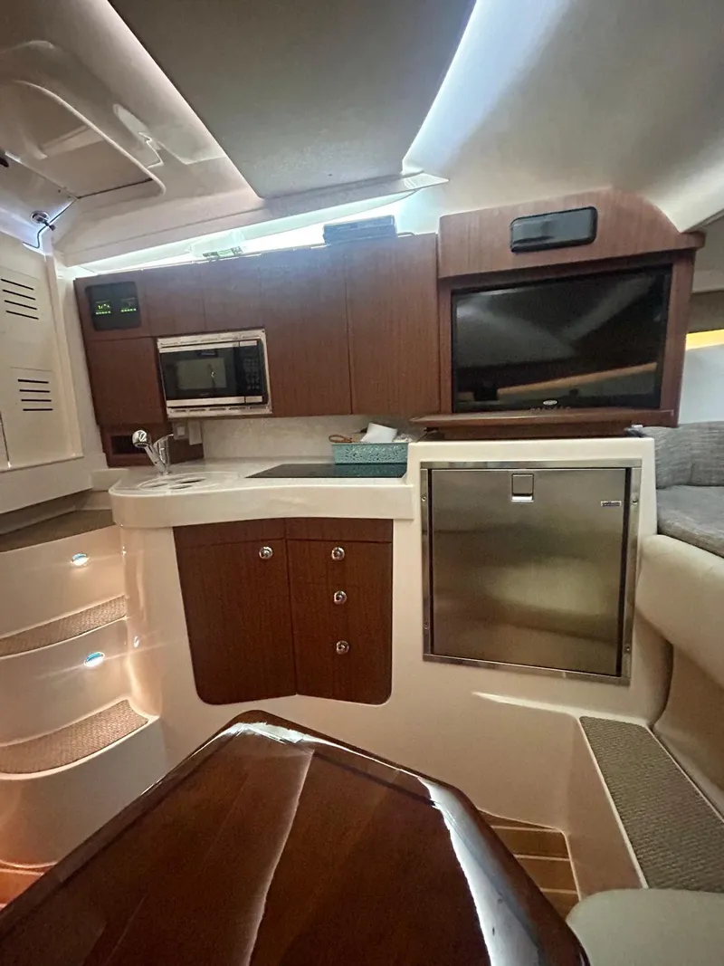 Slide: The Image of Interior of 2021 Grady-White Express 330 boat with modern kitchen and seating area. - 21
