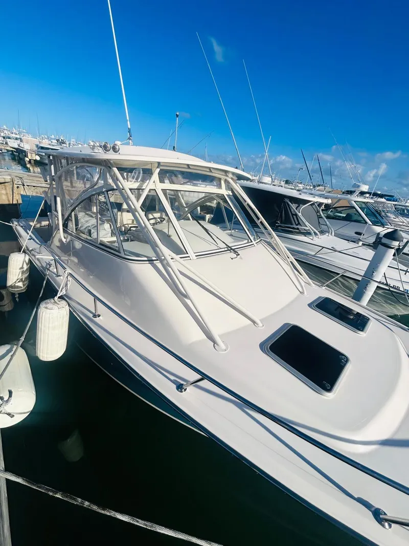 Slide: The Image of 2021 Grady-White Express 330 boat docked in marina under clear blue sky. - 5