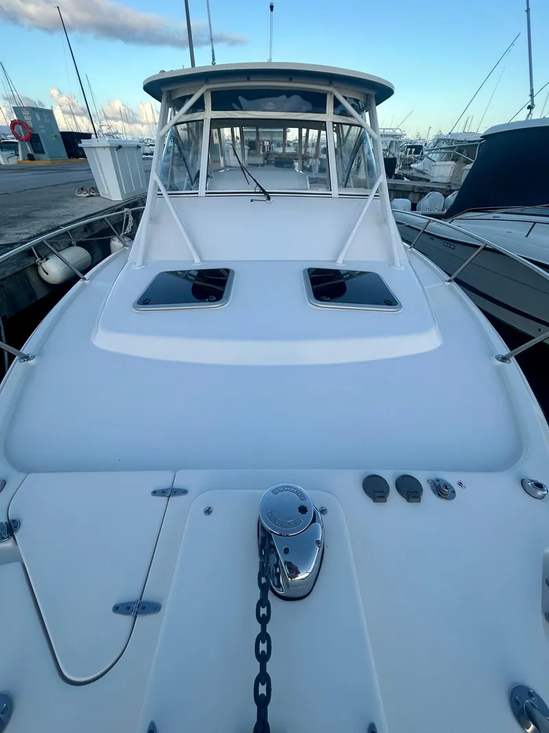 Slide: The Image of 2021 Grady-White Express 330 boat docked at marina, front view. - 6