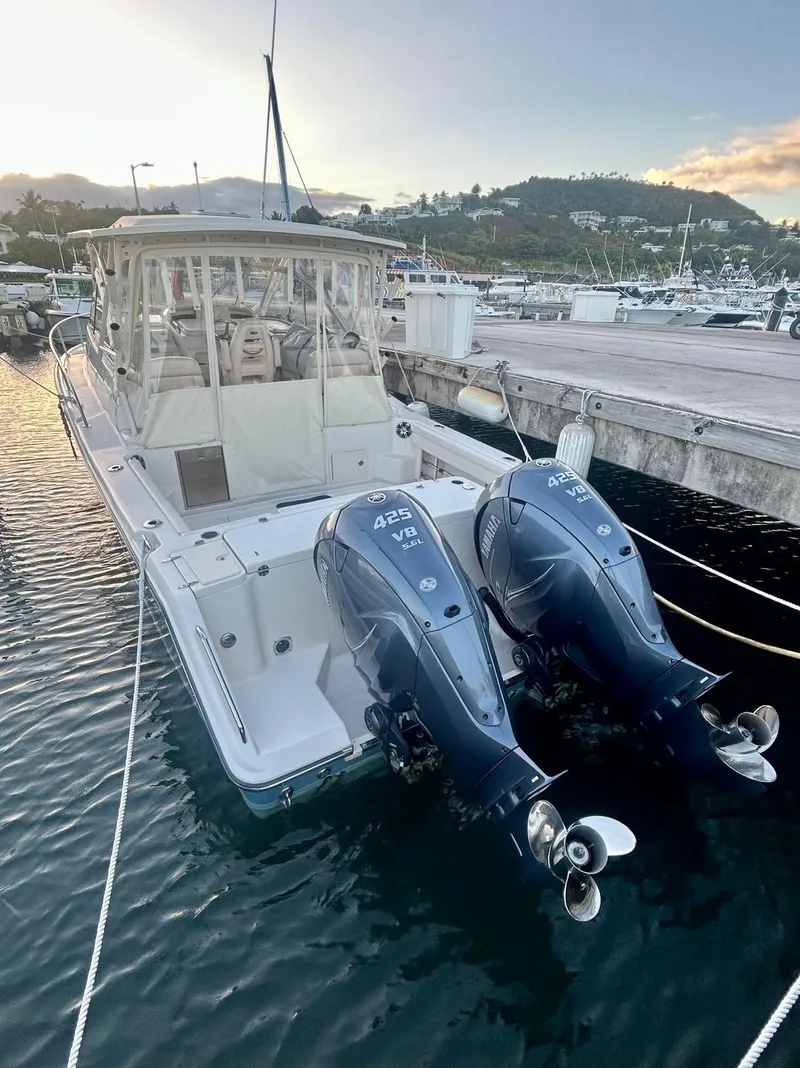 Slide: The Image of 2021 Grady-White Express 330 boat docked with twin outboard engines at sunset. - 9