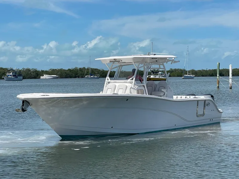 Slide: The Image of 2020 Sea Fox 328 Commander boat cruising on a calm, scenic waterway. - 1