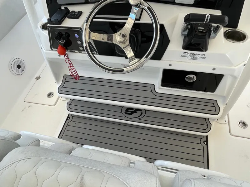 Slide: The Image of 2020 Sea Fox 328 Commander helm with steering wheel and controls. - 12