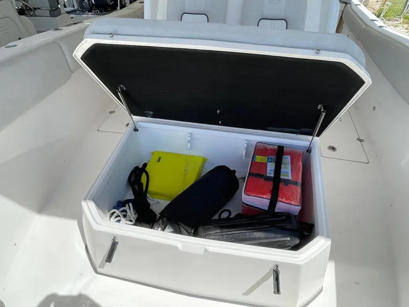 Slide: The Image of Open storage compartment on 2020 Sea Fox 328 Commander boat with safety gear. - 16