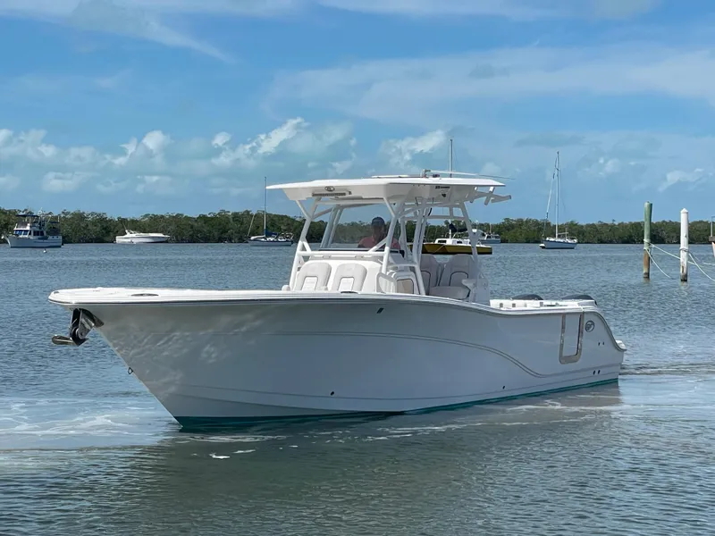 Slide: The Image of 2020 Sea Fox 328 Commander boat cruising on a calm, scenic waterway. - 2