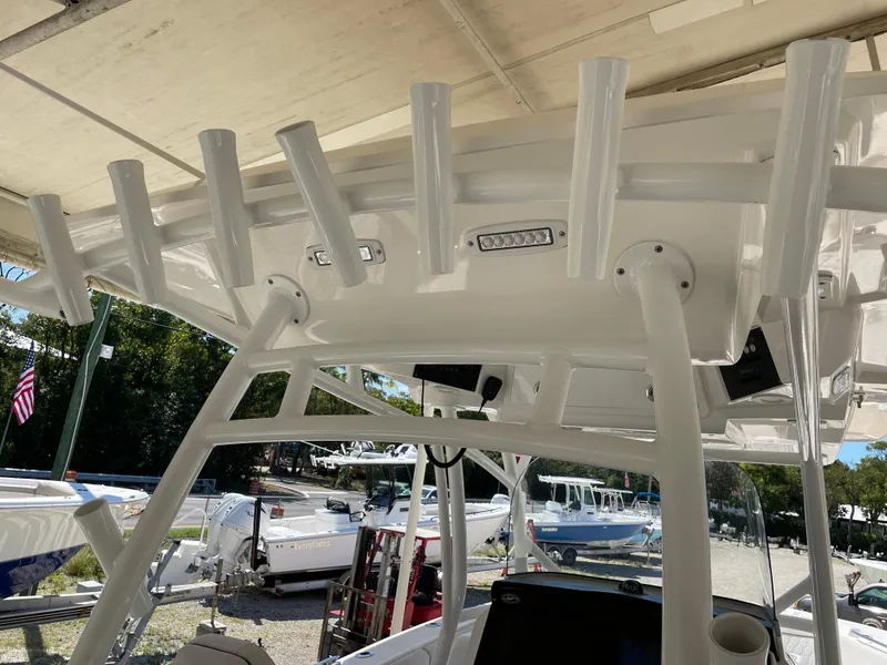 Slide: The Image of 2020 Sea Fox 328 Commander boat with rod holders and canopy structure. - 29