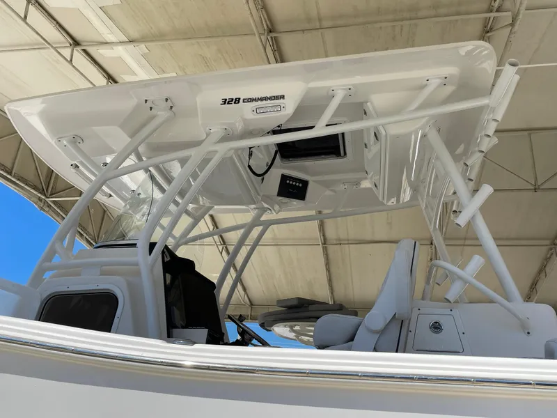 Slide: The Image of 2020 Sea Fox 328 Commander boat, featuring a sleek helm and T-top under a canopy. - 35