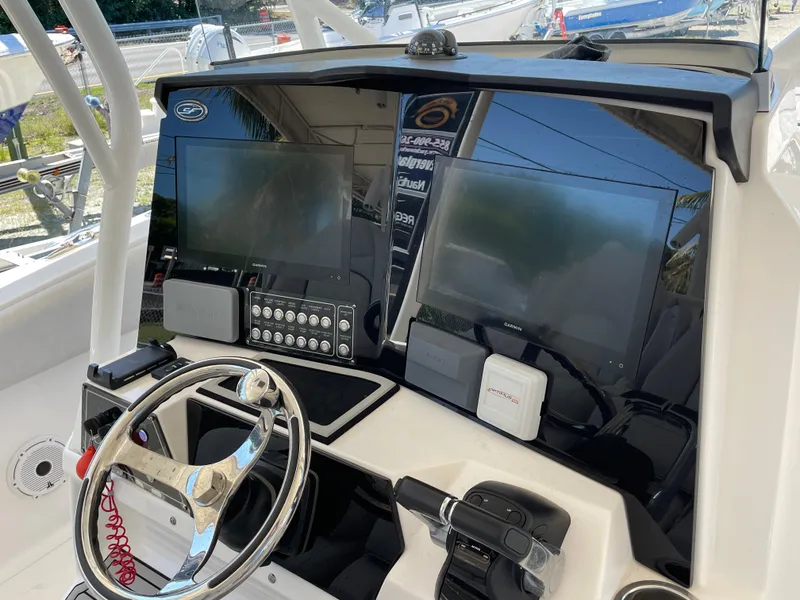 Slide: The Image of 2020 Sea Fox 328 Commander helm with dual displays and modern controls. - 7