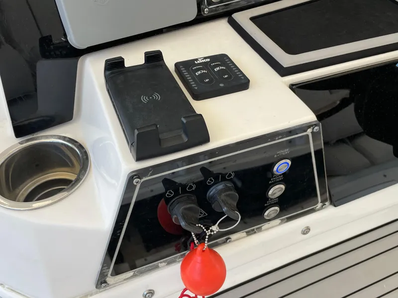 Slide: The Image of Control panel of a 2020 Sea Fox 328 Commander boat with cup holder and key fob. - 9