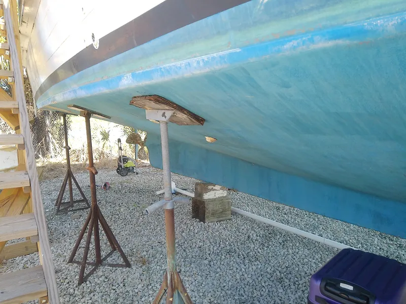 Slide: The Image of 1975 Marine Trader 40 Double Cabin boat hull on stands, gravel ground. - 10