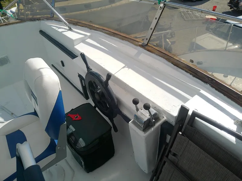 Slide: The Image of 1975 Marine Trader 40 Double Cabin helm with steering wheel and controls. - 12