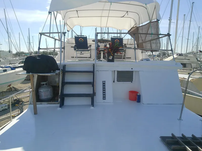 Slide: The Image of 1975 Marine Trader 40 Double Cabin yacht with upper deck seating and canopy. - 15