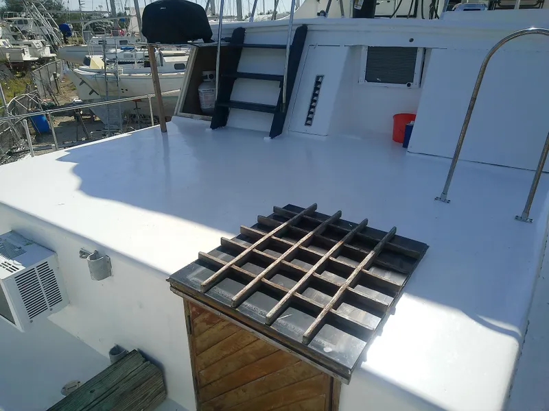 Slide: The Image of 1975 Marine Trader 40 Double Cabin deck with ladder and wooden hatch. - 16