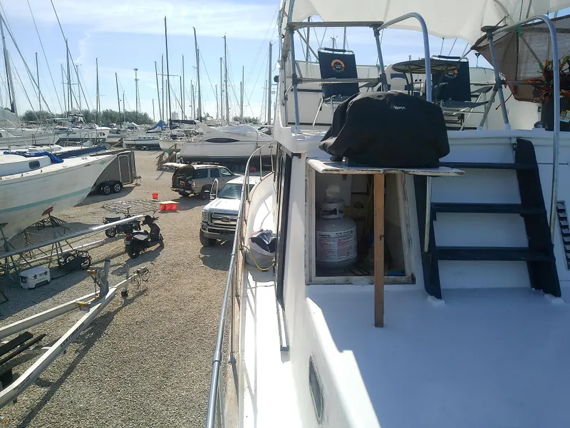 Slide: The Image of 1975 Marine Trader 40 Double Cabin yacht in a boatyard with other vessels. - 18