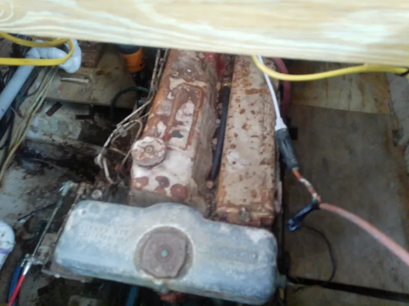 Slide: The Image of Engine compartment of a 1975 Marine Trader 40 Double Cabin, showing aged machinery and wiring. - 19