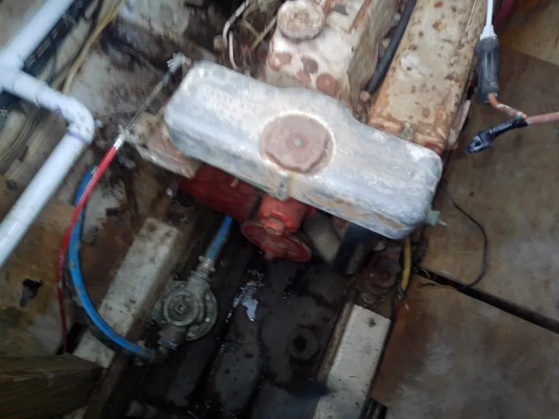 Slide: The Image of Engine compartment of a 1975 Marine Trader 40 Double Cabin boat, showing mechanical components. - 20