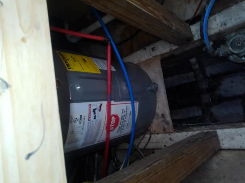 Slide: The Image of 1975 Marine Trader 40 Double Cabin interior showing plumbing and water heater setup. - 22