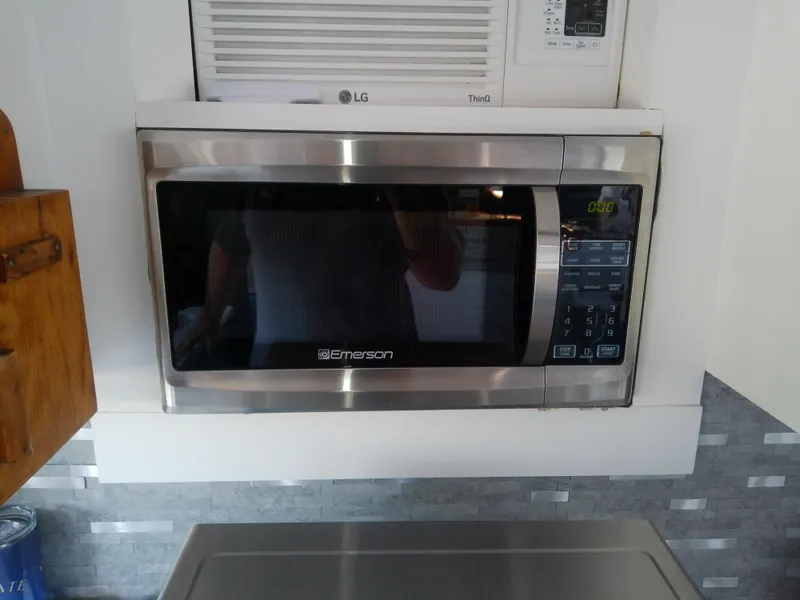 Slide: The Image of Emerson microwave in a kitchen setting on a 1975 Marine Trader 40 Double Cabin boat. - 32