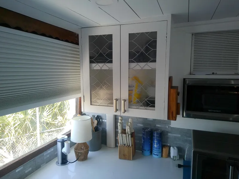 Slide: The Image of 1975 Marine Trader 40 Double Cabin kitchen with glass cabinets and modern appliances. - 33