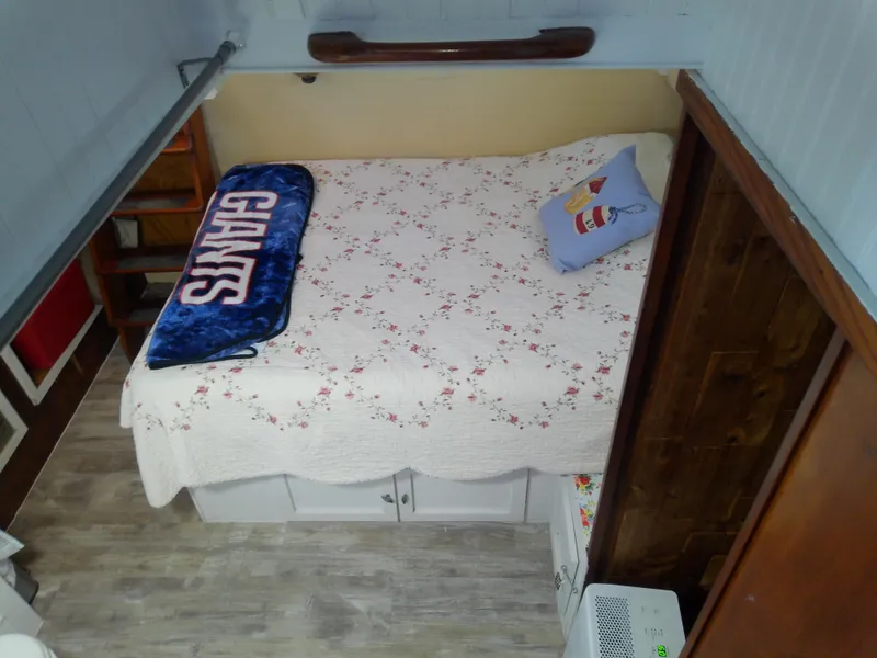 Slide: The Image of Cozy cabin bedroom in 1975 Marine Trader 40 Double Cabin boat with floral bedding. - 37