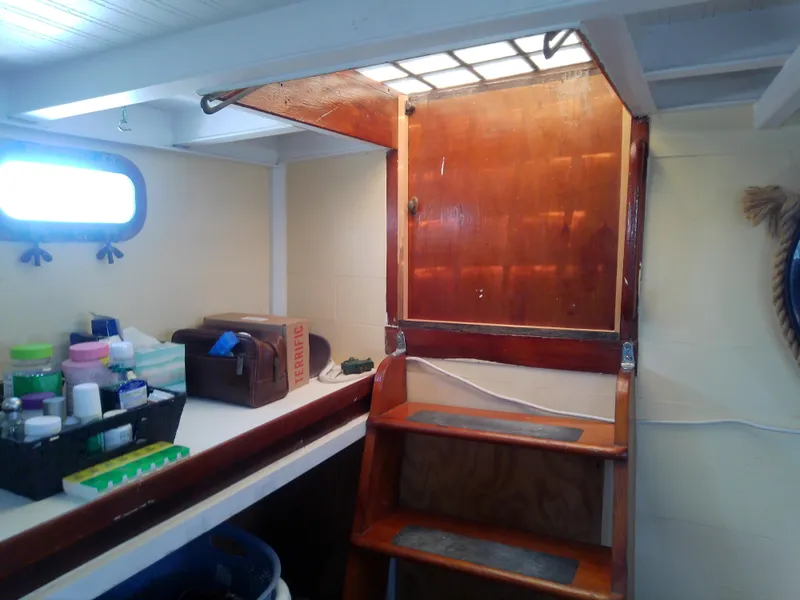 Slide: The Image of 1975 Marine Trader 40 Double Cabin interior with wooden stairs and storage area. - 39