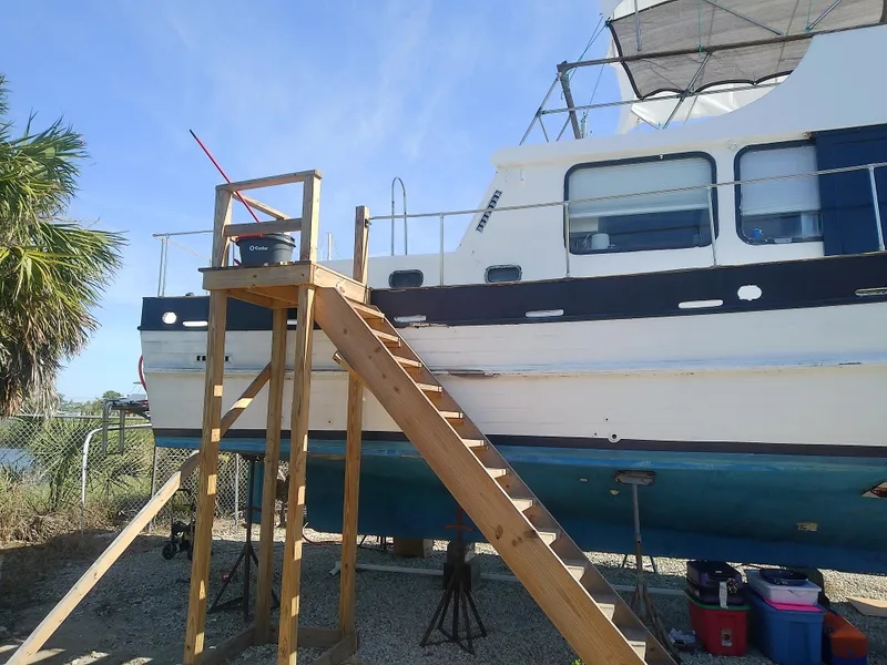 Slide: The Image of 1975 Marine Trader 40 Double Cabin boat on dry dock with wooden stairs. - 4