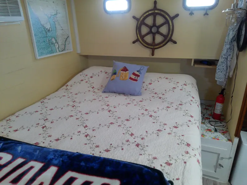 Slide: The Image of Cozy cabin interior of 1975 Marine Trader 40 Double Cabin with nautical decor and floral bedding. - 43