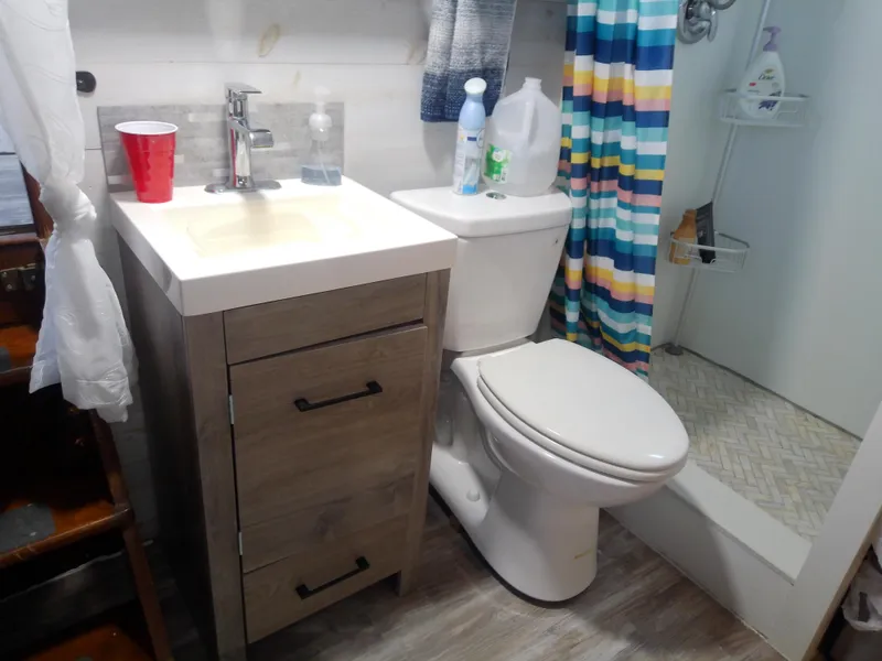 Slide: The Image of Bathroom in 1975 Marine Trader 40 Double Cabin with sink, toilet, and shower. - 44